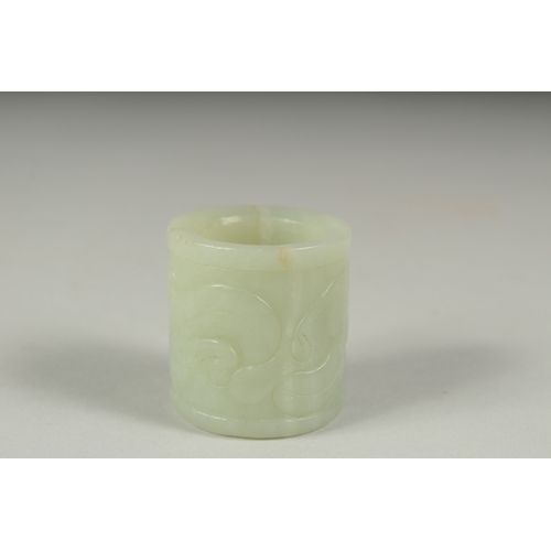 27 - AN EARLY 20TH CENTURY CHINESE CARVED JADE RING, 3.5cm long.