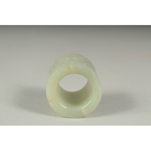 27 - AN EARLY 20TH CENTURY CHINESE CARVED JADE RING, 3.5cm long.