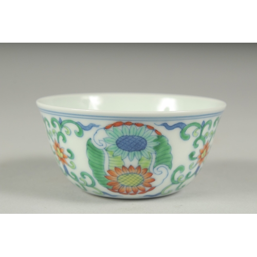 37 - A CHINESE DOUCAI PORCELAIN CUP, decorated with floral motifs, character mark to base, 8cm diameter.