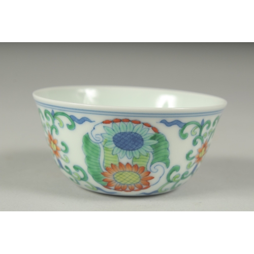 37 - A CHINESE DOUCAI PORCELAIN CUP, decorated with floral motifs, character mark to base, 8cm diameter.