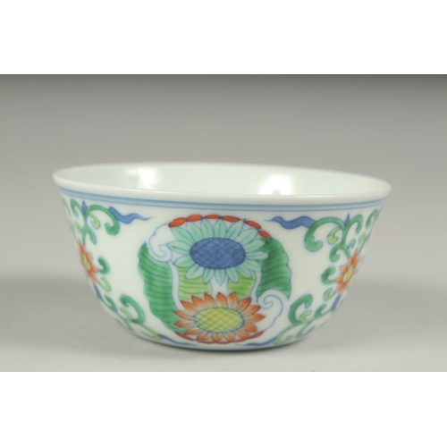 37 - A CHINESE DOUCAI PORCELAIN CUP, decorated with floral motifs, character mark to base, 8cm diameter.