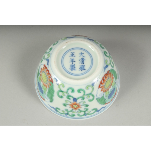 37 - A CHINESE DOUCAI PORCELAIN CUP, decorated with floral motifs, character mark to base, 8cm diameter.