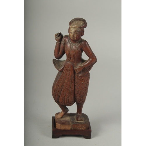 41 - A CHINESE CARVED WOOD FIGURE AND STAND.