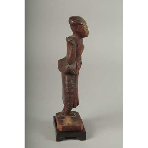 41 - A CHINESE CARVED WOOD FIGURE AND STAND.