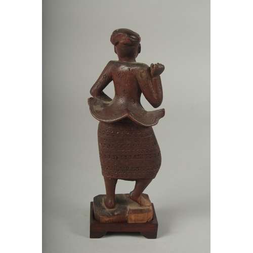 41 - A CHINESE CARVED WOOD FIGURE AND STAND.