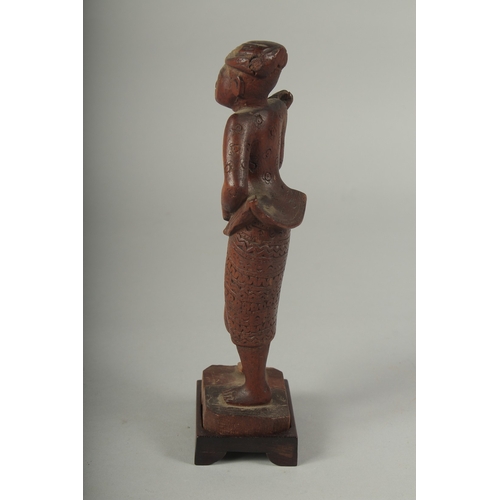 41 - A CHINESE CARVED WOOD FIGURE AND STAND.