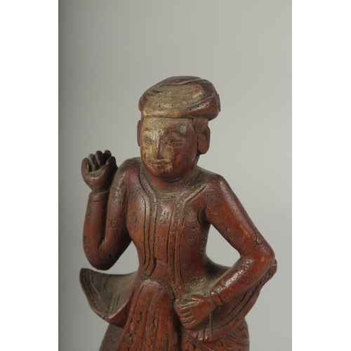 41 - A CHINESE CARVED WOOD FIGURE AND STAND.