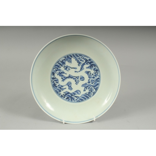 45A - A CHINESE BLUE AND WHITE PORCELAIN DRAGON PLATE, with incised white dragon on stylised waves, six-ch... 