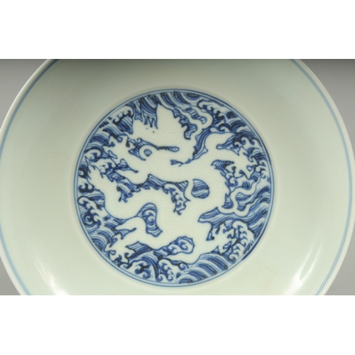 45A - A CHINESE BLUE AND WHITE PORCELAIN DRAGON PLATE, with incised white dragon on stylised waves, six-ch... 