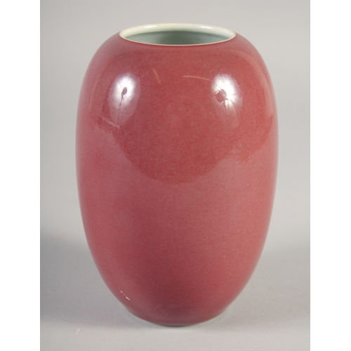 47 - A CHINESE COPPER RED PORCELAIN POT, six-character mark to base, 15cm high.