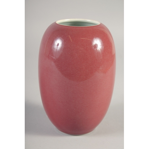 47 - A CHINESE COPPER RED PORCELAIN POT, six-character mark to base, 15cm high.