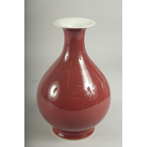 493 - A CHINESE RED GLAZED PORCELAIN VASE, character mark to base, 23cm high.