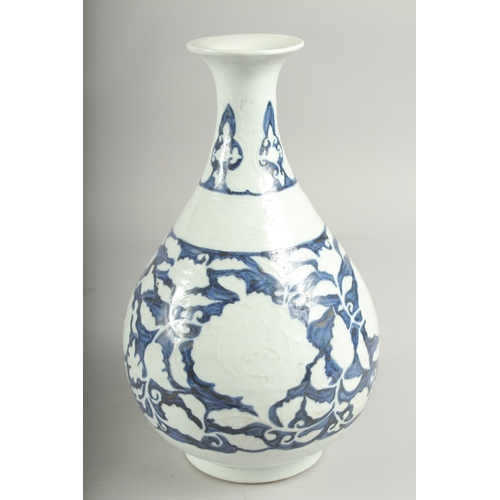 495 - A CHINESE BLUE AND WHITE PORCELAIN VASE, with white floral decoration, character mark to base, 29.5c... 