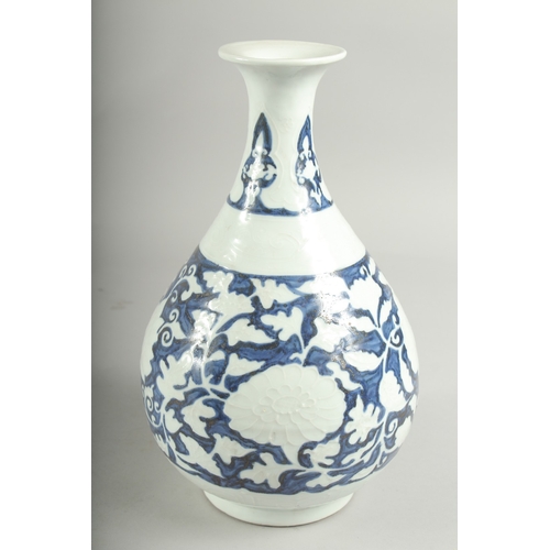 495 - A CHINESE BLUE AND WHITE PORCELAIN VASE, with white floral decoration, character mark to base, 29.5c... 