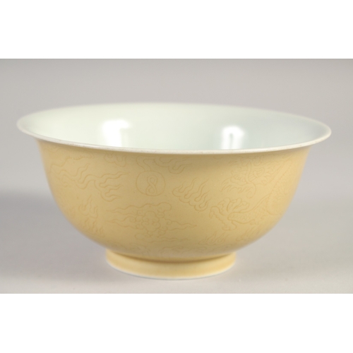 50 - A CHINESE YELLOW GLAZE PORCELAIN DRAGON BOWL, six-character mark to base, 14.5cm diameter.