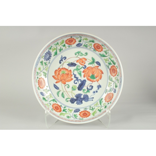 51 - A CHINESE SANCAI LOTUS PORCELAIN CHARGER, 33cm diameter.