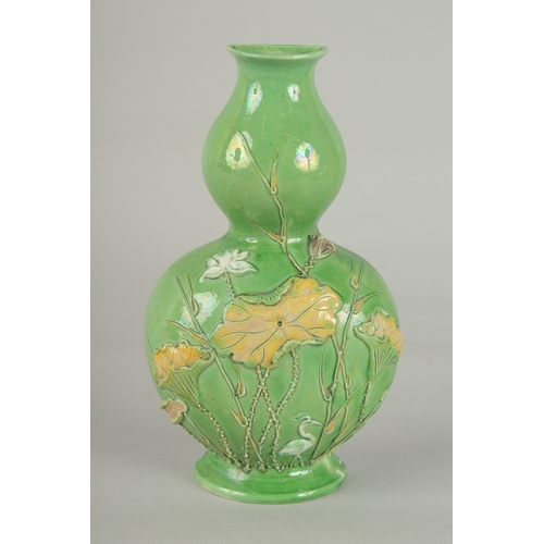 52 - AN EARLY 20TH CENTURY CHINESE GREEN GROUND DOUBLE GOURD WALL VASE, with relief decoration, 21cm high... 