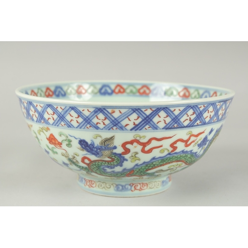 55 - A CHINESE WUCAI PORCELAIN BOWL, painted with dragons and flora, 20.5cm diameter.