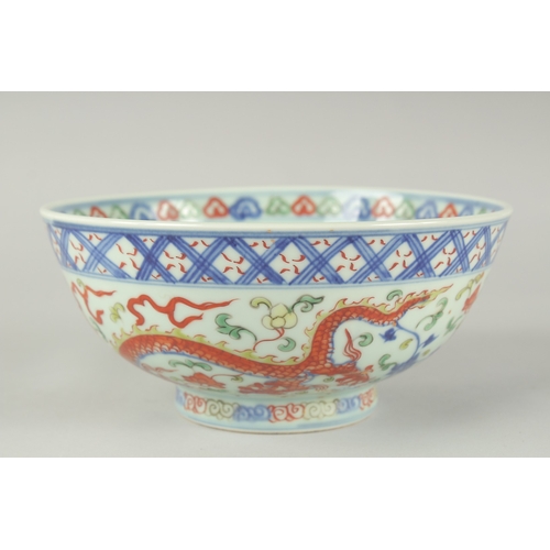 55 - A CHINESE WUCAI PORCELAIN BOWL, painted with dragons and flora, 20.5cm diameter.