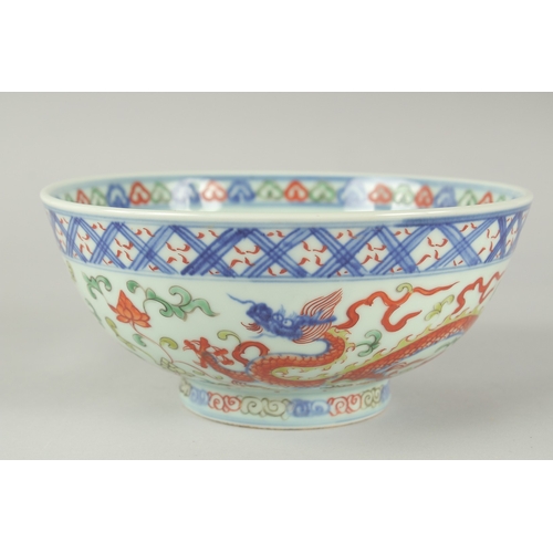 55 - A CHINESE WUCAI PORCELAIN BOWL, painted with dragons and flora, 20.5cm diameter.