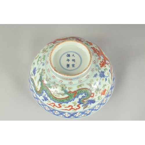 55 - A CHINESE WUCAI PORCELAIN BOWL, painted with dragons and flora, 20.5cm diameter.