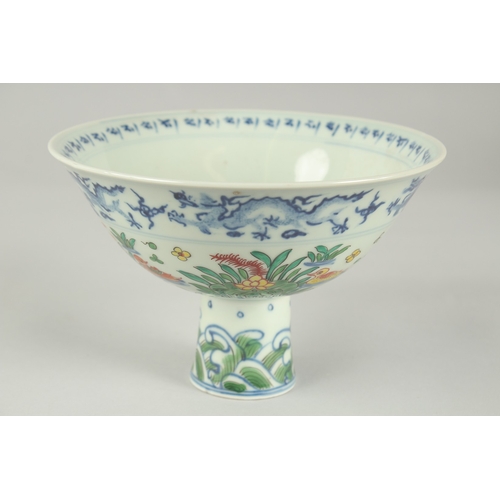 56 - A CHINESE WUCAI PORCELAIN STEM CUP, painted with ducks and aquatic flora, bowl 17cm diameter.