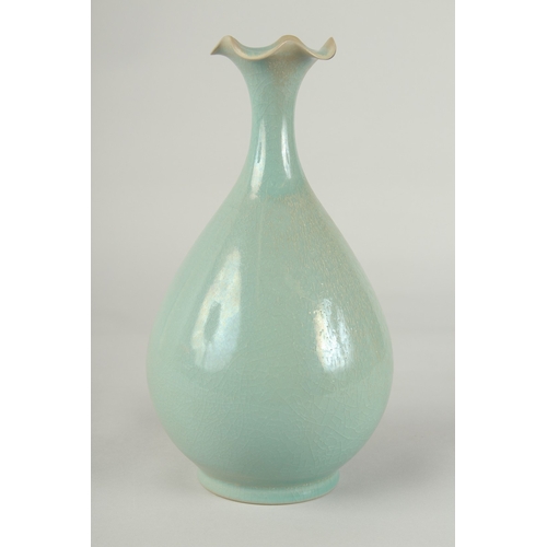 58 - A CHINESE CELADON GLAZE PORCELAIN VASE, with stylised petal-formed rim, 27cm high.