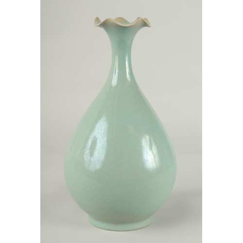 58 - A CHINESE CELADON GLAZE PORCELAIN VASE, with stylised petal-formed rim, 27cm high.