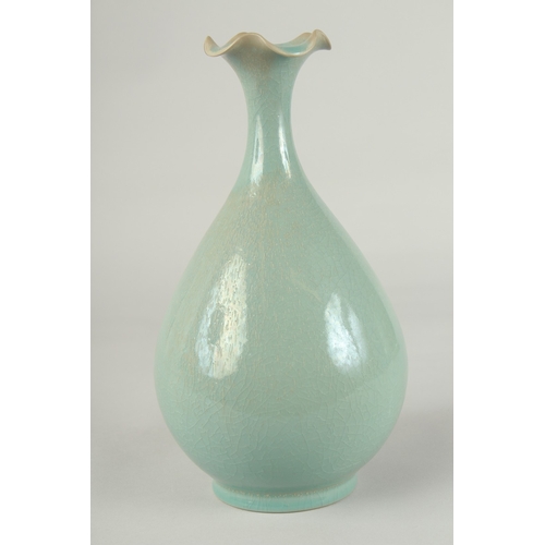 58 - A CHINESE CELADON GLAZE PORCELAIN VASE, with stylised petal-formed rim, 27cm high.