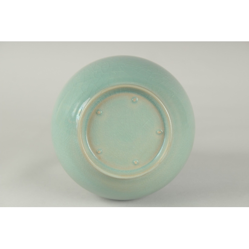 58 - A CHINESE CELADON GLAZE PORCELAIN VASE, with stylised petal-formed rim, 27cm high.