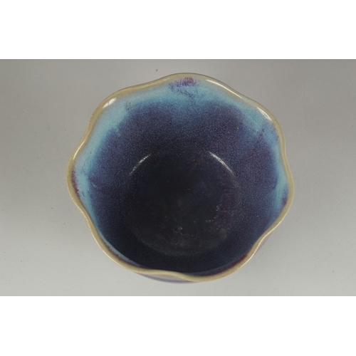 59 - A CHINESE JUN WARE PORCELAIN BOWL, with wavey rim, 16.5cm wide.