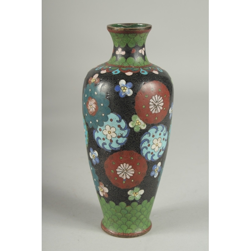 6 - A BLACK GROUND CLOISONNE VASE, with decorative floral roundels and green scale pattern, 21.5cm high.