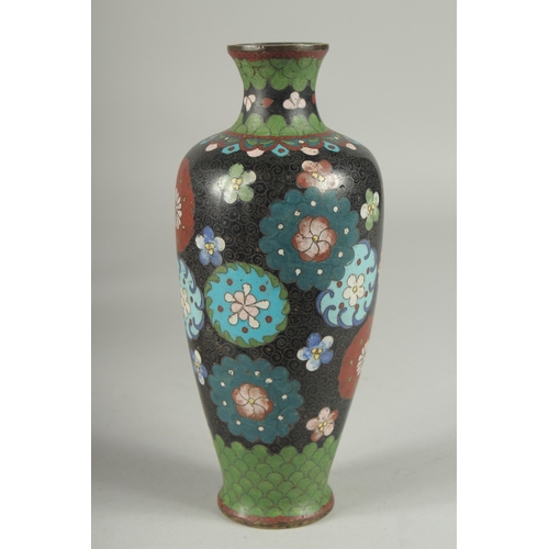 6 - A BLACK GROUND CLOISONNE VASE, with decorative floral roundels and green scale pattern, 21.5cm high.