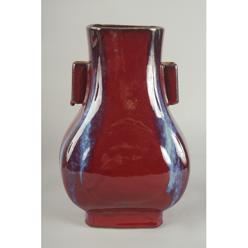 63 - A CHINESE FLAMBE GLAZE PORCELAIN TWIN HANDLE VASE, 28cm high.