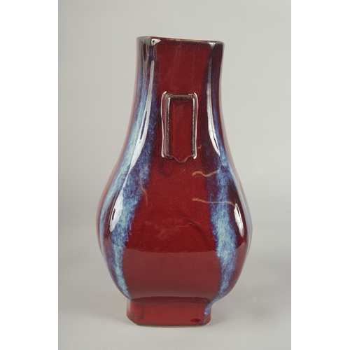 63 - A CHINESE FLAMBE GLAZE PORCELAIN TWIN HANDLE VASE, 28cm high.