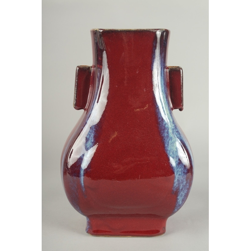 63 - A CHINESE FLAMBE GLAZE PORCELAIN TWIN HANDLE VASE, 28cm high.