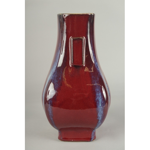 63 - A CHINESE FLAMBE GLAZE PORCELAIN TWIN HANDLE VASE, 28cm high.