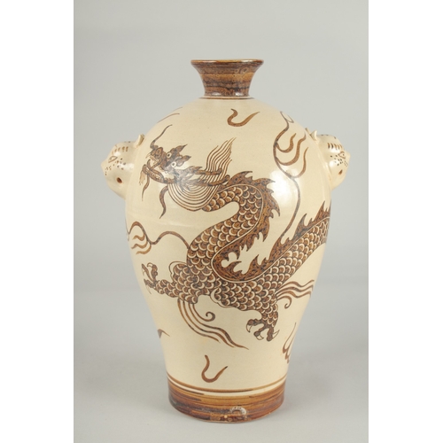 64 - A CHINESE CIZHOU DRAGON VASE, with moulded twin handles, 29.5cm high.