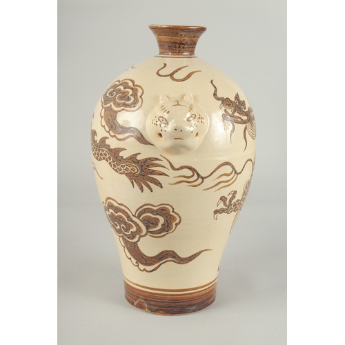 64 - A CHINESE CIZHOU DRAGON VASE, with moulded twin handles, 29.5cm high.