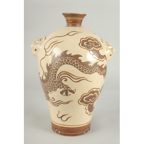 64 - A CHINESE CIZHOU DRAGON VASE, with moulded twin handles, 29.5cm high.