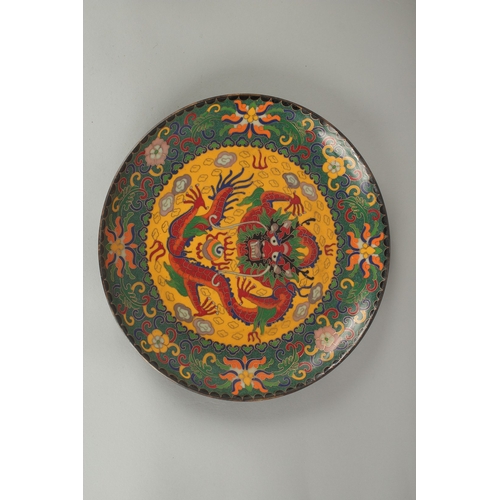 67 - A CHINESE CLOISONNE DRAGON DISH, 25cm diameter.