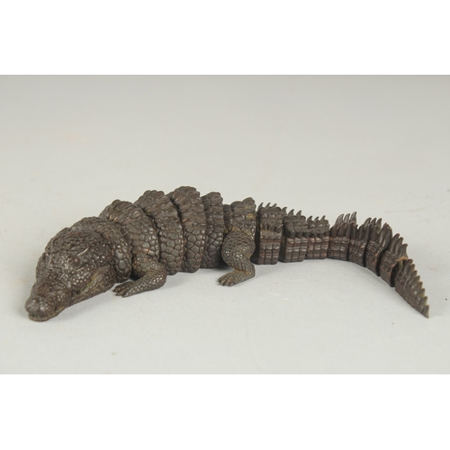 81 - A JAPANESE BRONZE RETICULATED OKIMONO OF A CROCODILE, with mark to underside of head, 21cm long.