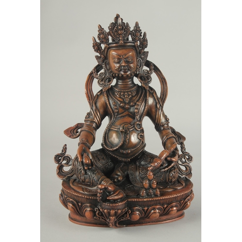 84 - A TIBETAN BRONZE SEATED DEITY, on a lotus base, 29.5cm high.