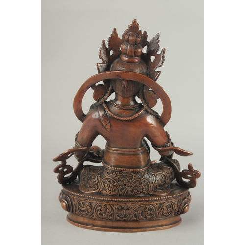 84 - A TIBETAN BRONZE SEATED DEITY, on a lotus base, 29.5cm high.