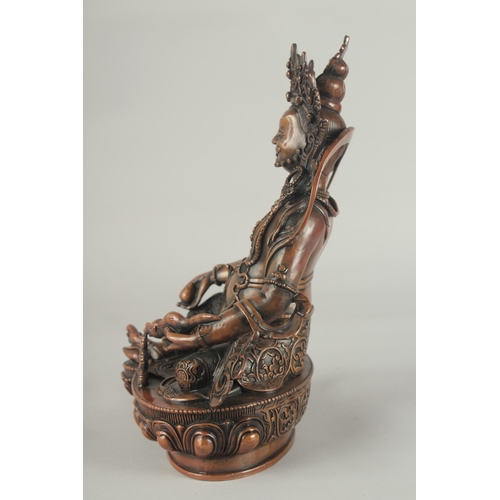 84 - A TIBETAN BRONZE SEATED DEITY, on a lotus base, 29.5cm high.