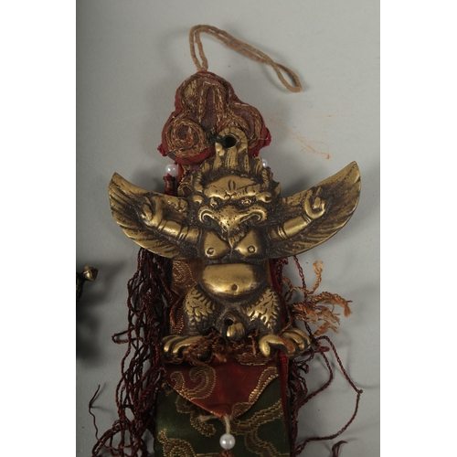 86 - A SMALL TIBETAN FOUR-PRONG VAJRA AND GARUDA HANGING ORNAMENT, (2).