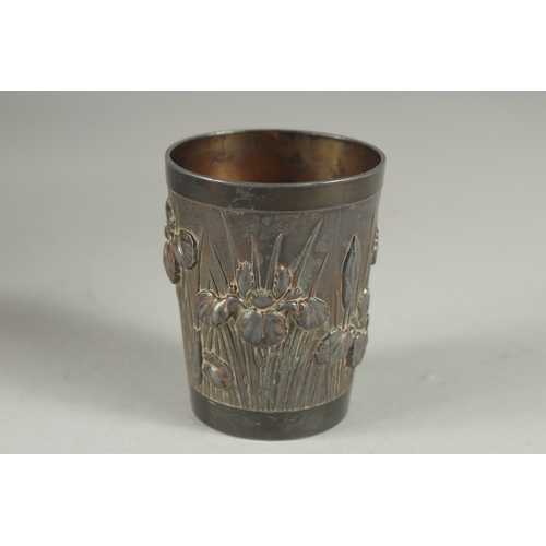 9 - A CHINESE METAL BEAKER, relief decorated with flora, 6cm high.