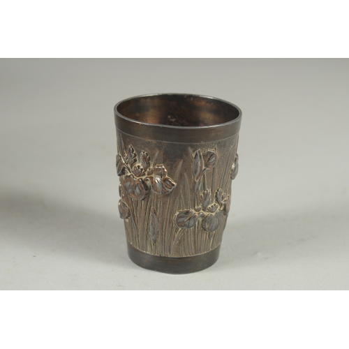 9 - A CHINESE METAL BEAKER, relief decorated with flora, 6cm high.