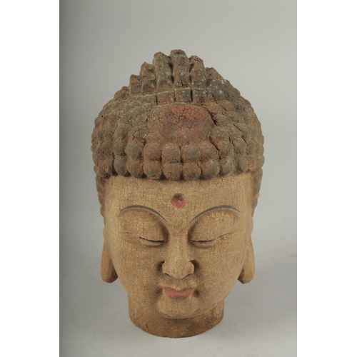 91 - AN ARCHAIC WOOD GUANYIN HEAD, 22cm high.