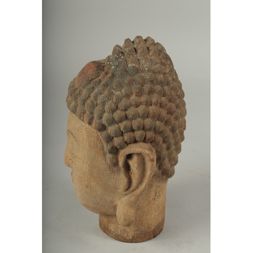 91 - AN ARCHAIC WOOD GUANYIN HEAD, 22cm high.